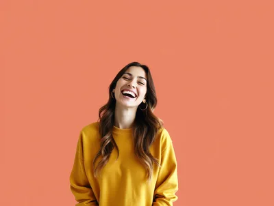 Happy Young Woman Laughing Against Orange Background