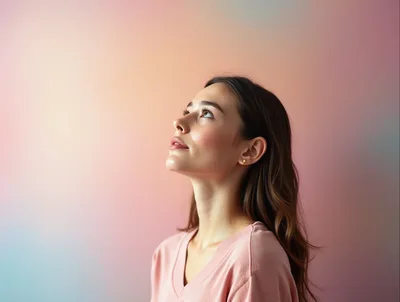 Young Woman Looking Upwards With Hopeful Expression