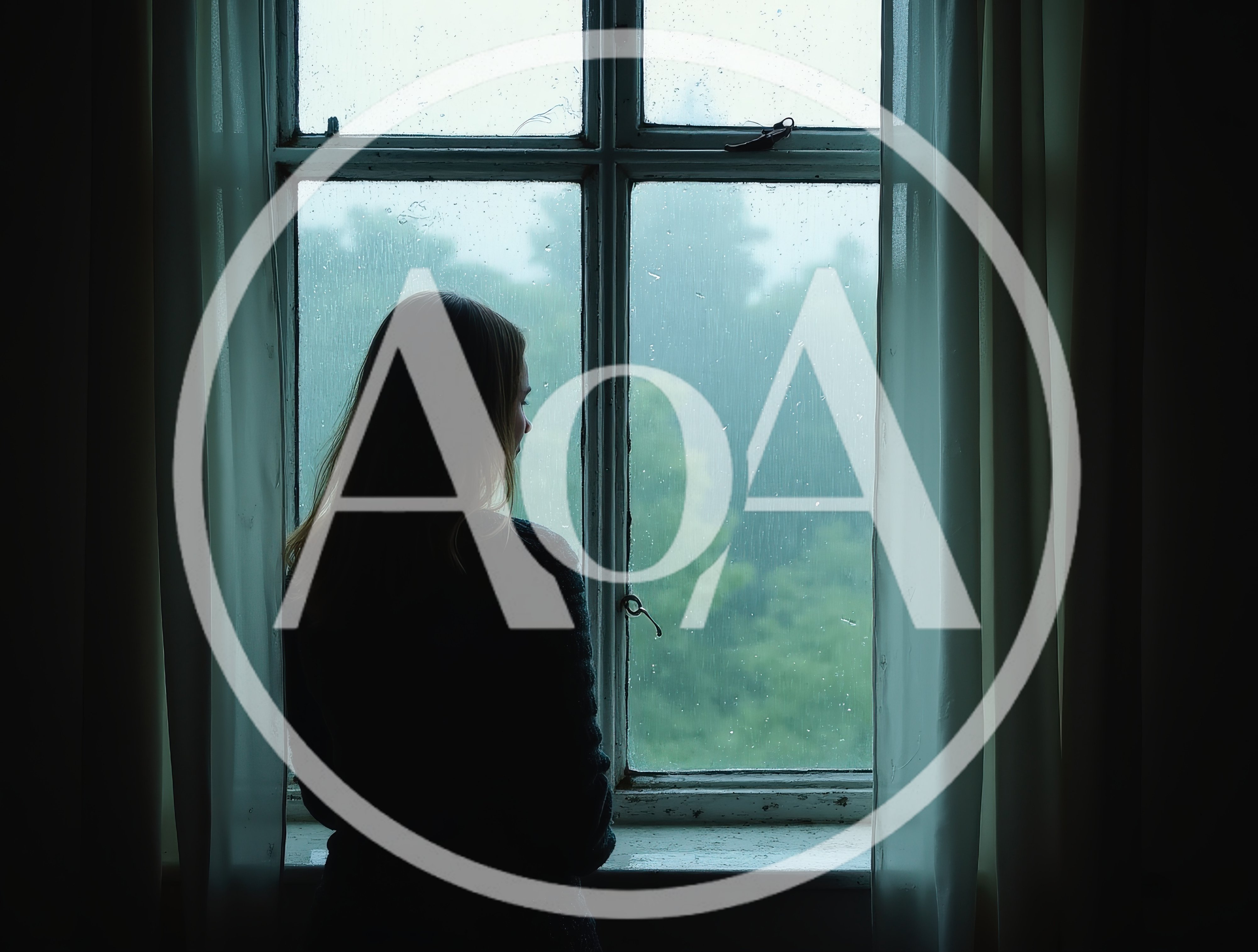 Young Woman Looking Out A Rainy Window