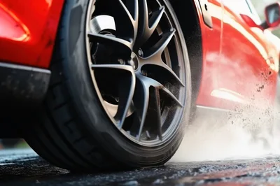 Red Sports Car Performing A Tire Burnout