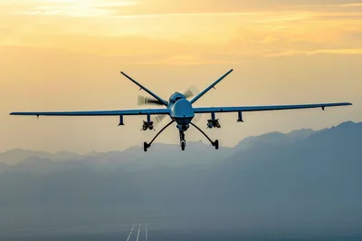 MQ-9 Reaper Drone Flying Over Mountainous Landscape