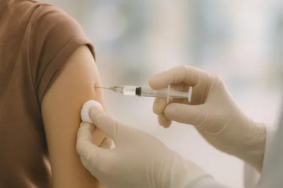 Medical Professional Administering Vaccine Injection To Patient