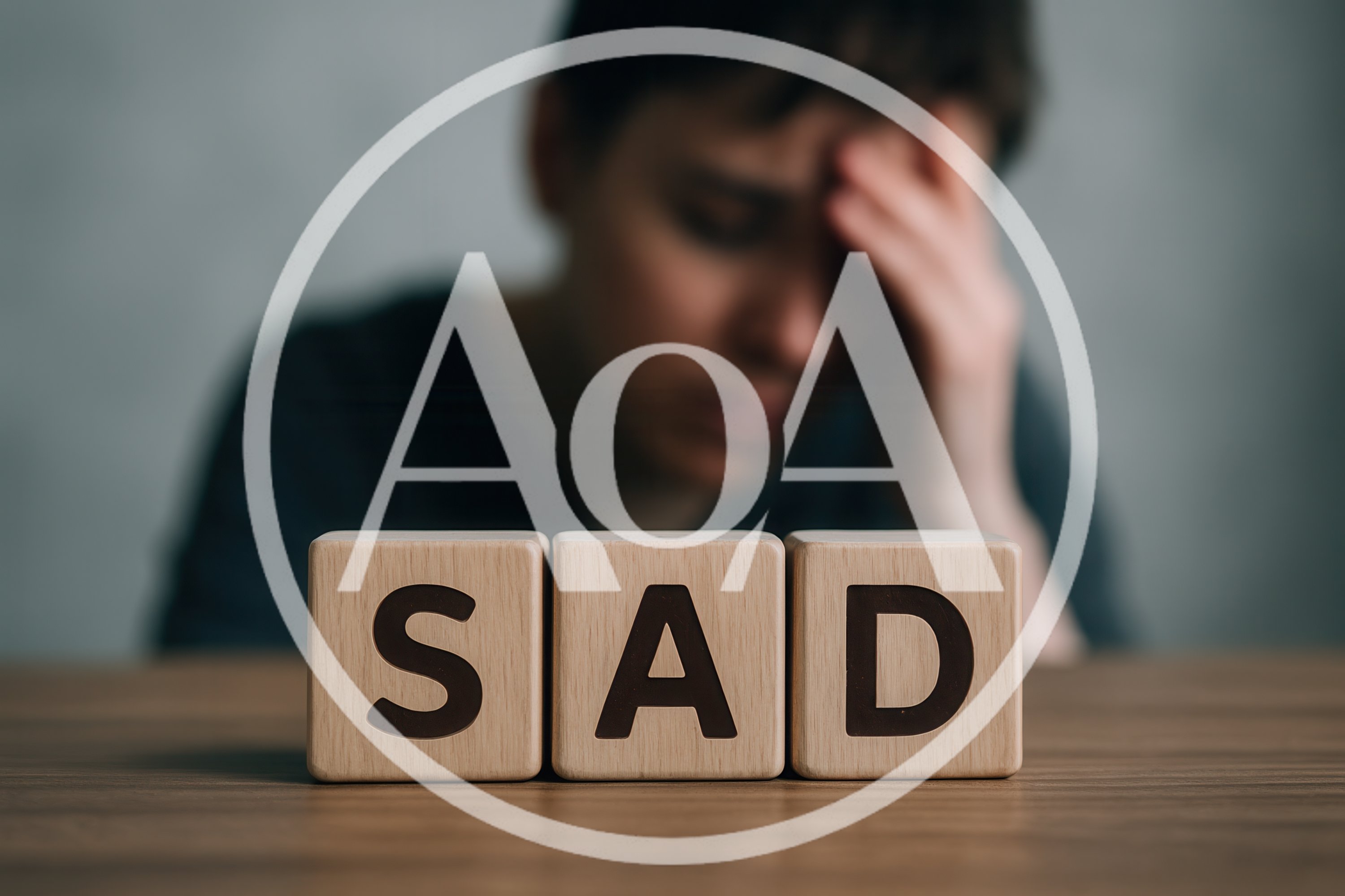 Person Feeling Sad With Wooden Blocks Spelling Sad
