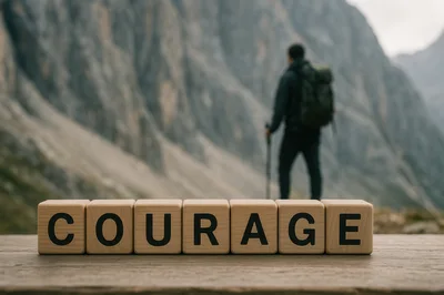 Wooden Blocks Spelling Courage With Hiker In Background