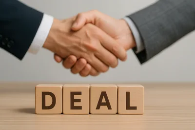 Business Partners Shaking Hands Over Wooden Deal Blocks