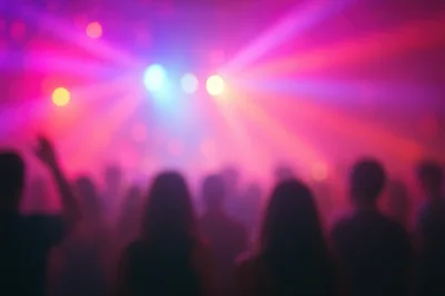 Crowd Dancing at a Nightclub with Colorful Stage Lights