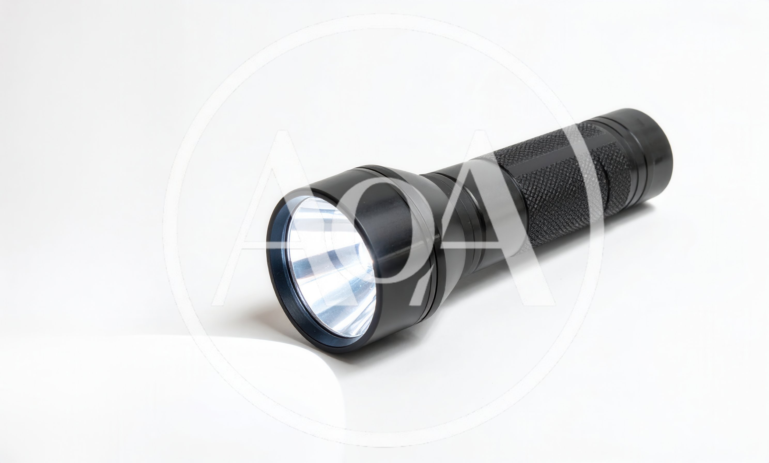 Black Metal Flashlight Shining Light On White Surface