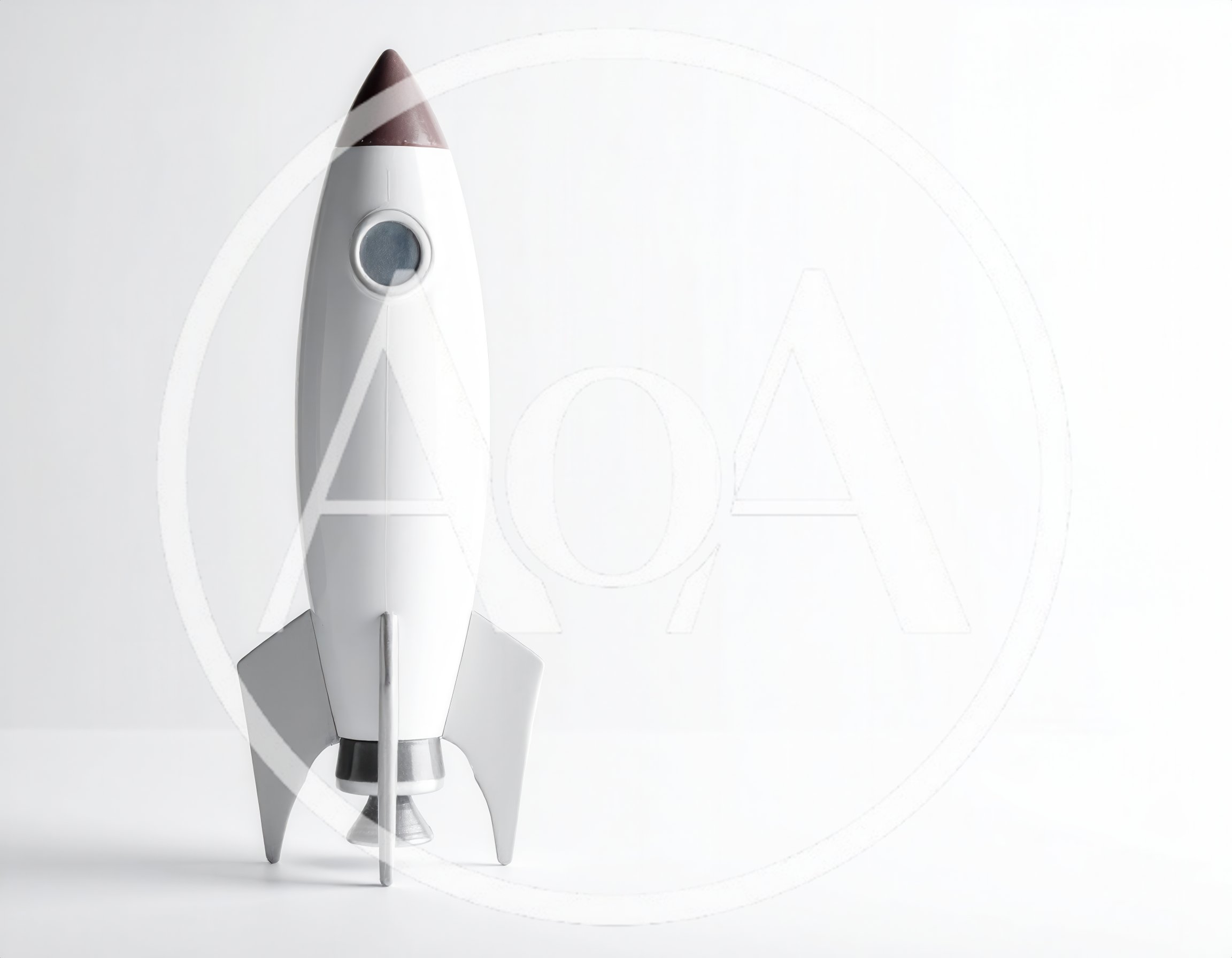 White Toy Rocket Ship Standing On White Background