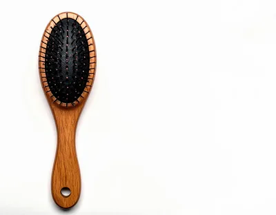 Wooden Hairbrush With Black Bristles On White Background