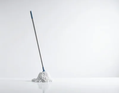 White Cotton Mop Standing Upright on White Background