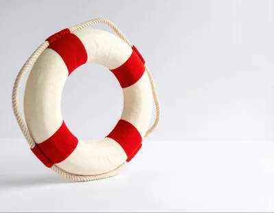 Red and White Lifebuoy Ring on White Background