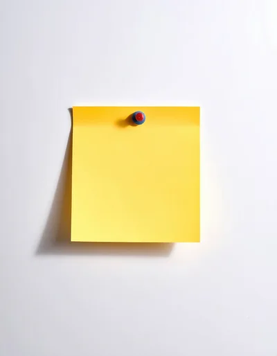 Yellow Sticky Note Pinned To A White Wall