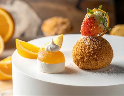 Gourmet Dessert Plating With Fried Ball And Citrus