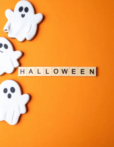Halloween Cookies and Letter Tiles on Orange Background