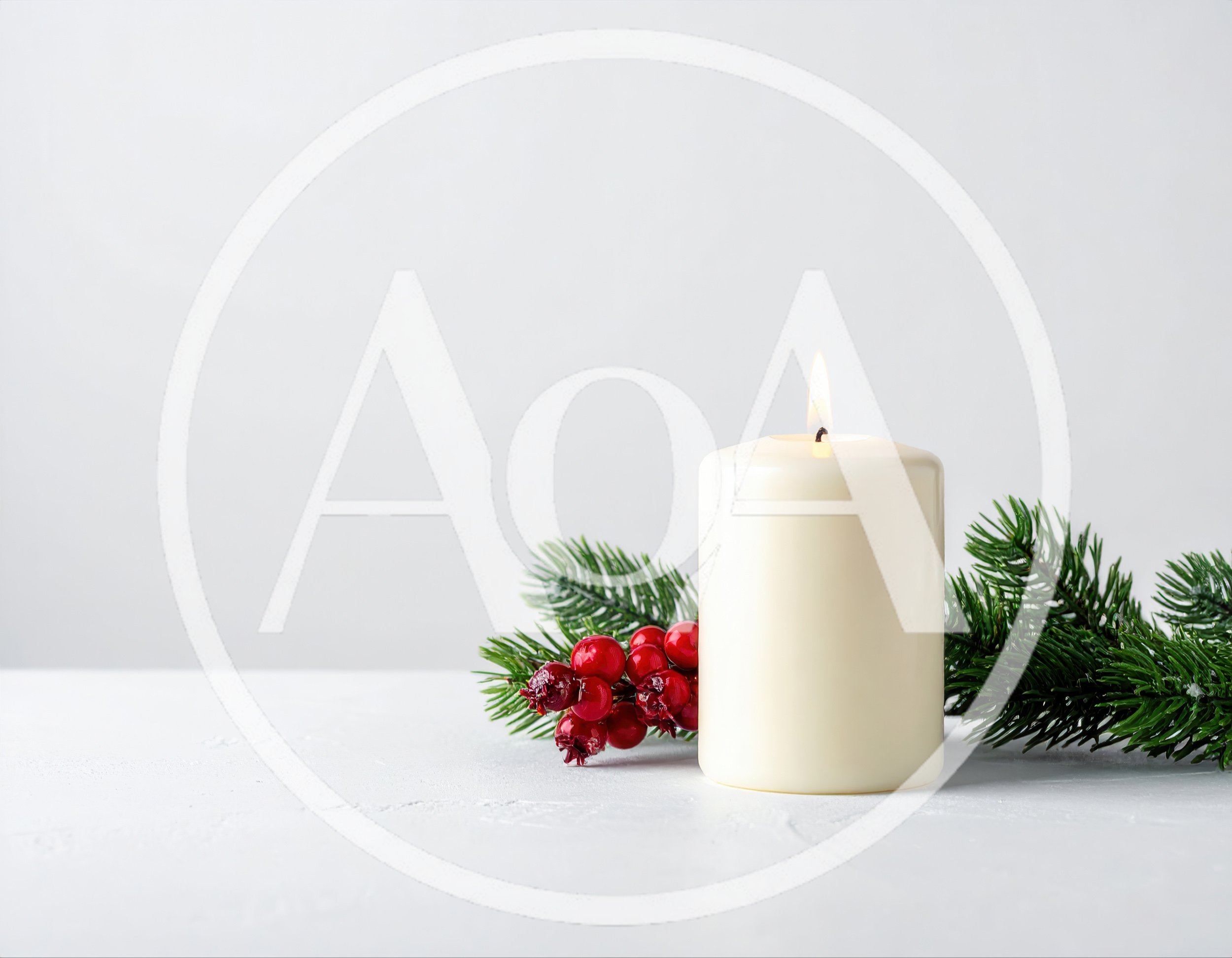 Lit White Pillar Candle With Christmas Greenery