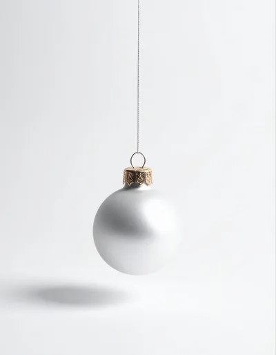 Silver Christmas Ornament Hanging Against White Background