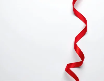 Red Satin Ribbon Curled On White Background