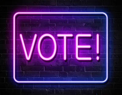 Neon Vote Sign On Dark Brick Wall