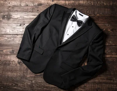Black Tuxedo Jacket and White Shirt on Wooden Background