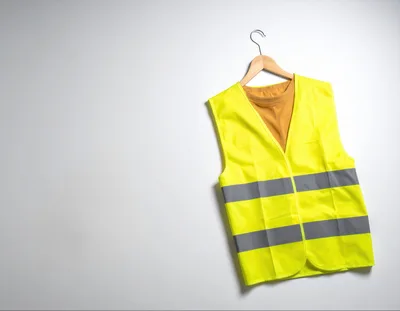 High Visibility Safety Vest Hanging On A Wooden Hanger