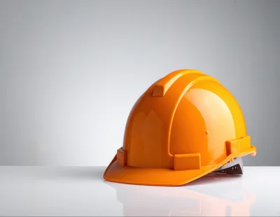 Orange Construction Hard Hat On White Surface