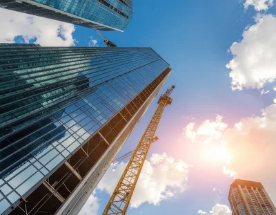 Modern Skyscrapers Under Construction With Tower Cranes
