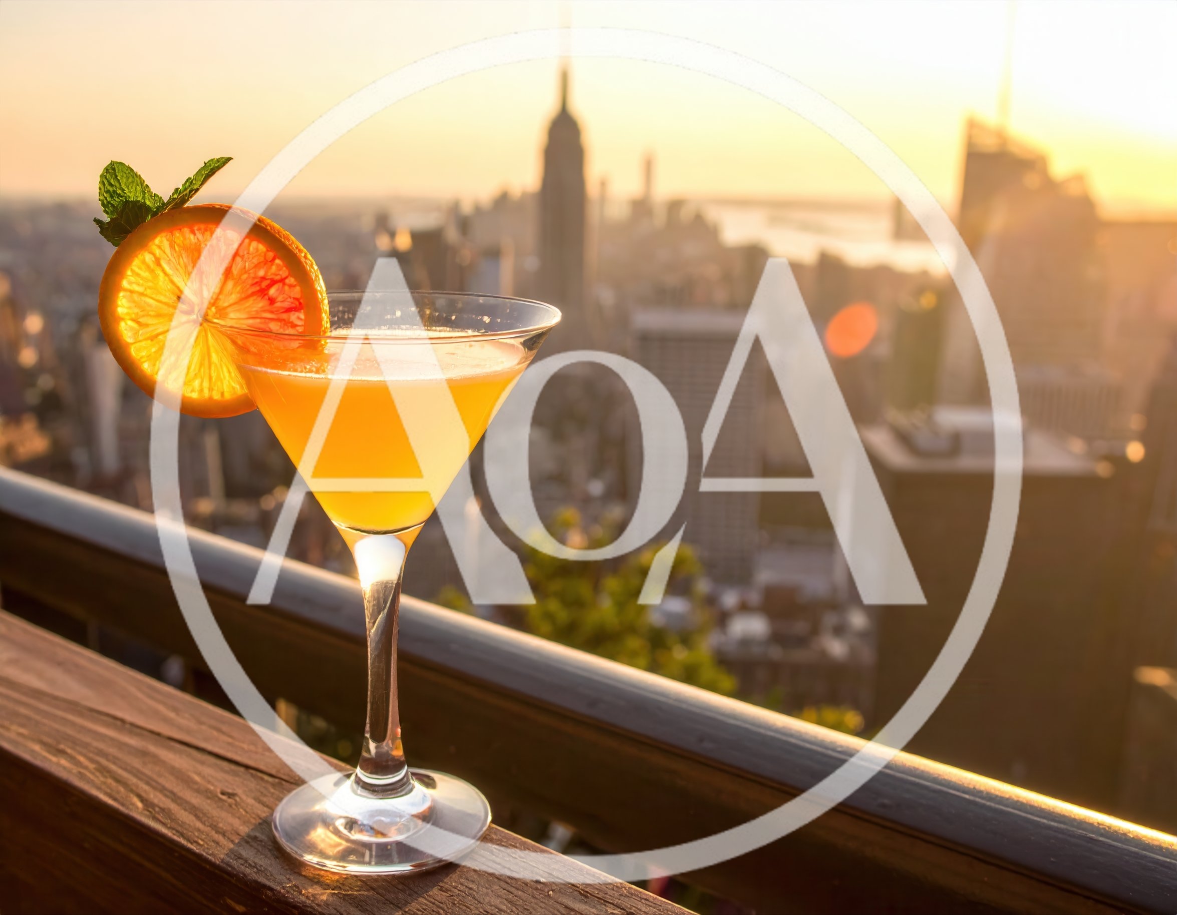 Cocktail Glass With Orange Garnish Overlooking New York City
