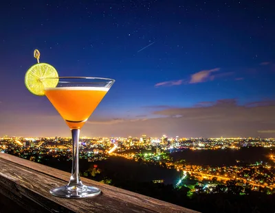 Cocktail Glass With Lime Garnish Overlooking City Skyline