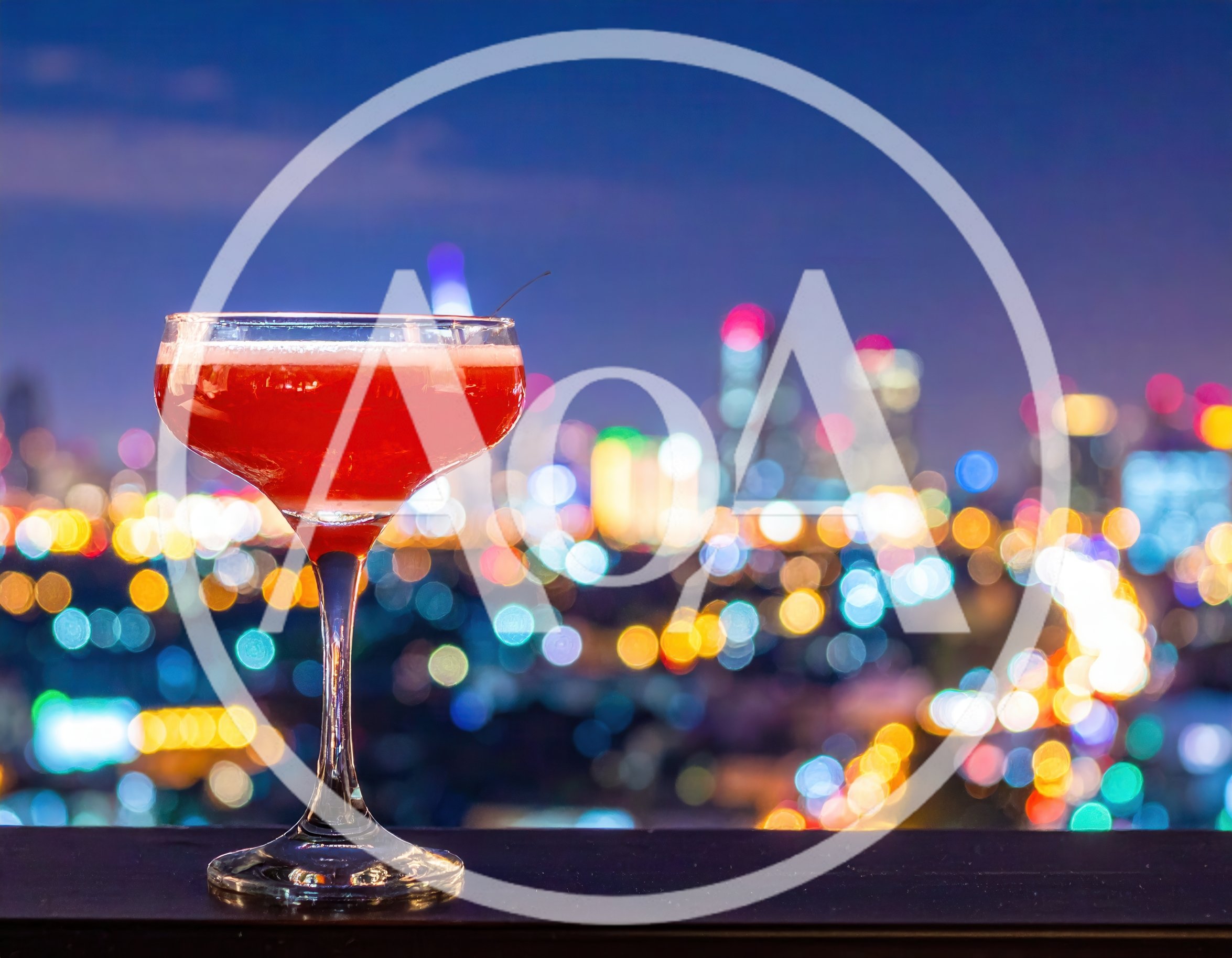 Red Cocktail Glass Against Blurred City Night Lights
