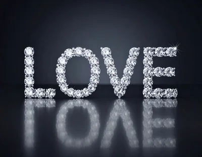 Diamond Studded Love Text On Reflective Surface