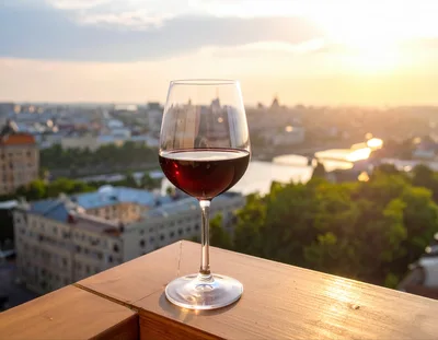 Glass Of Red Wine On A Rooftop At Sunset