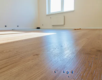 Newly Installed Light Oak Wood Flooring In Empty Room