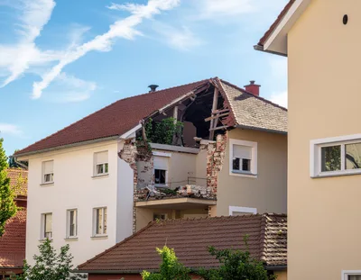 Damaged Residential Building With Structural Roof Collapse