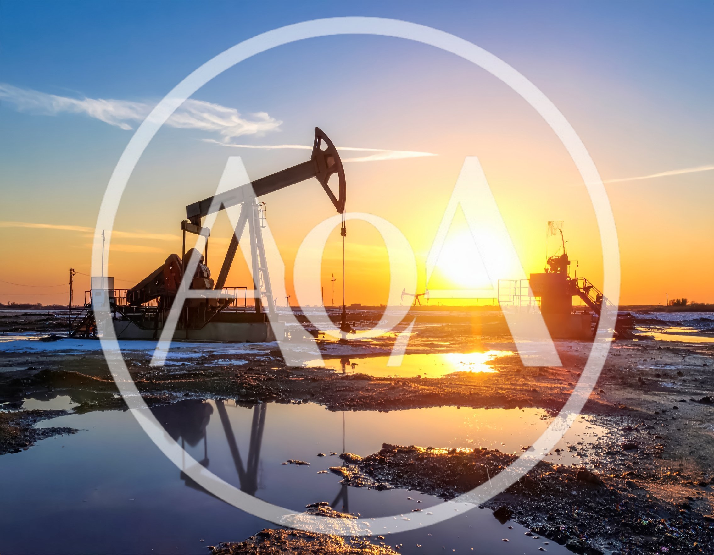 Oil Pump Jack Operating At Sunset