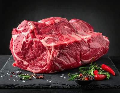 Raw Beef Ribeye Roast on Slate Board