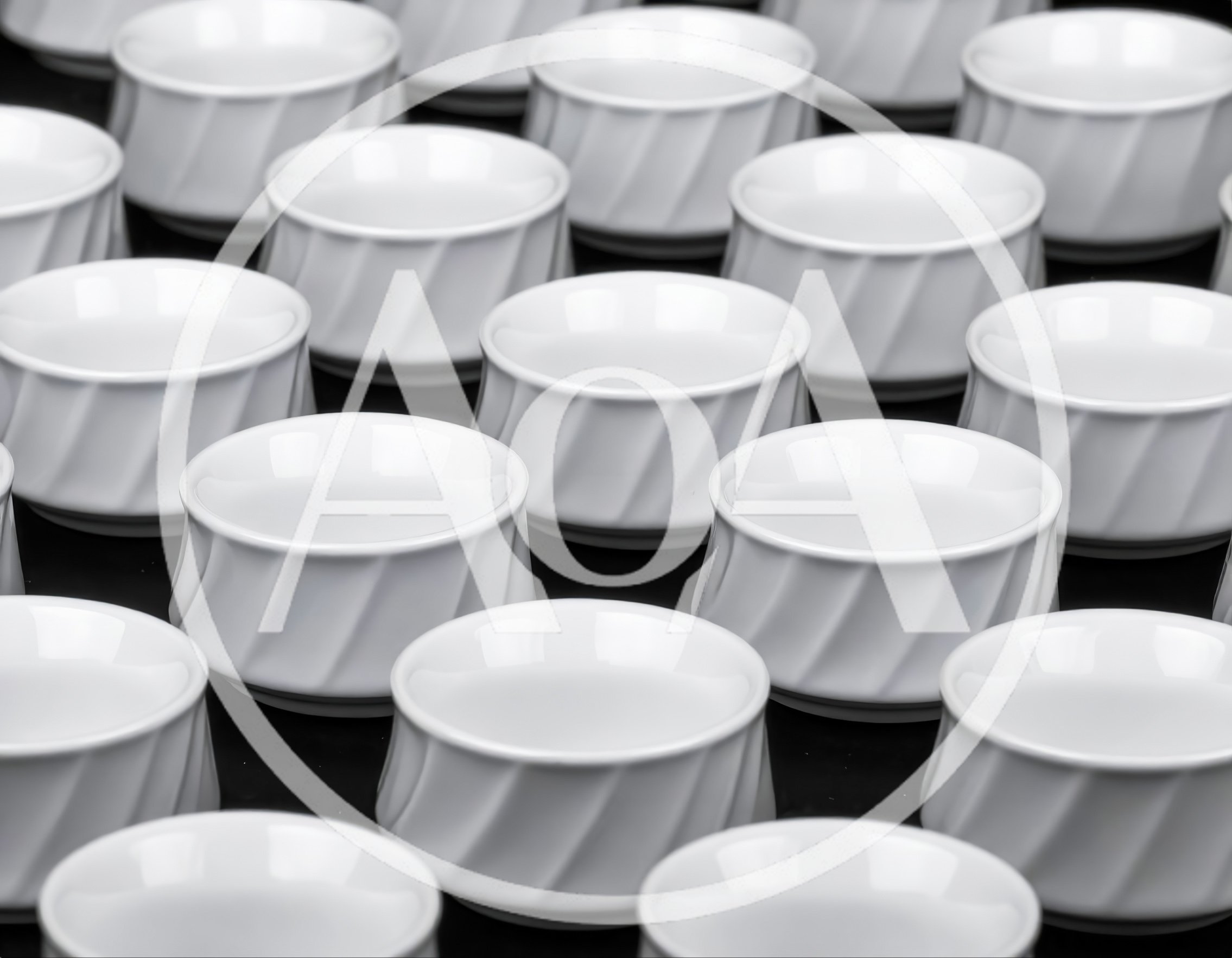 Rows of White Ceramic Bowls on Black Background