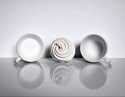 Two White Coffee Cups And A Marshmallow