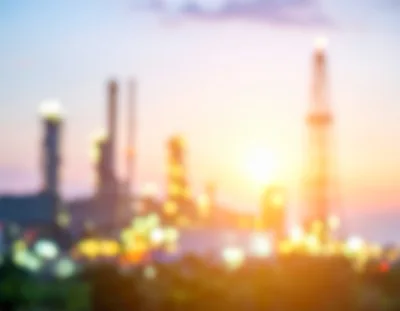 Blurred Industrial Oil Refinery At Sunset