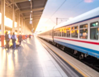Blurred Commuters Waiting At A Train Station Platform