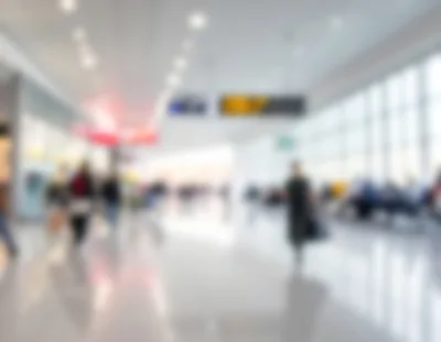 Blurred Passengers Walking Through A Modern Airport Terminal