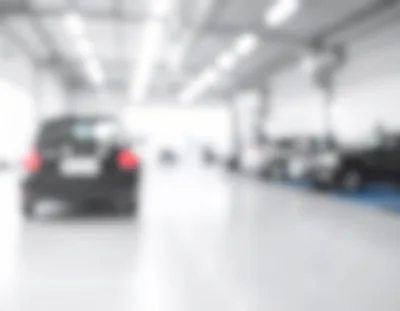 Blurred View of Cars Inside a Modern Auto Workshop