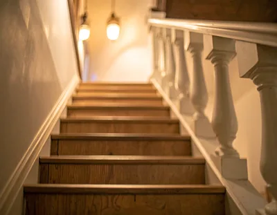 Low Angle View Of Wooden Staircase With White Railing