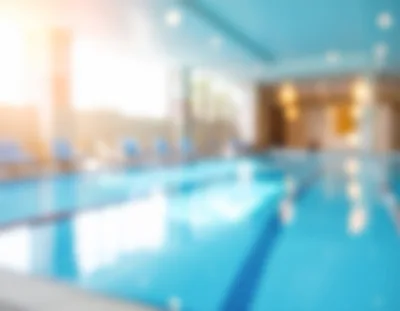 Blurred Indoor Swimming Pool With Lounge Chairs