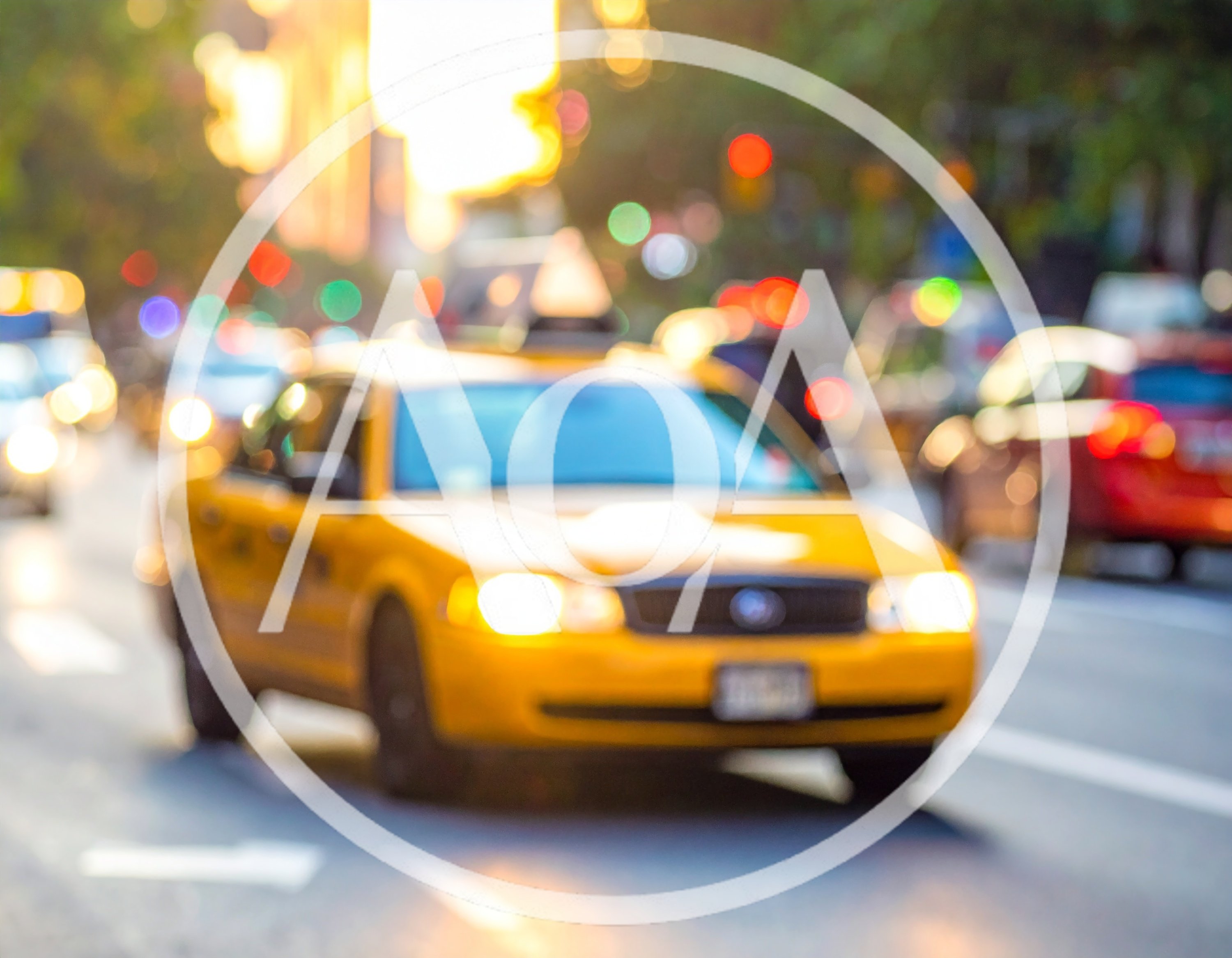 Yellow Taxi Cab Driving Through Busy City Street