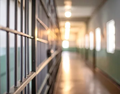 Empty Prison Corridor With Metal Barred Cells