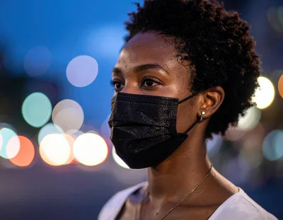 Young Woman Wearing A Black Face Mask Outdoors