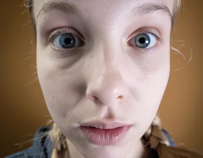 Close Up Portrait Of A Young Woman With Wide Eyes