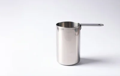 Stainless Steel Measuring Cup On White Background