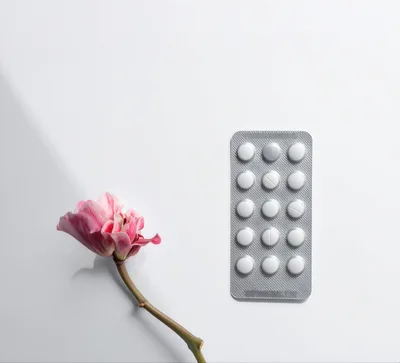 Pink Flower And Blister Pack Of White Pills