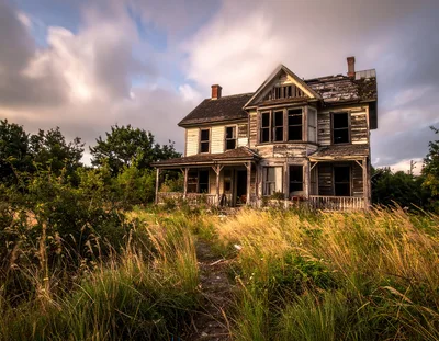 Abandoned Victorian House In Overgrown Field